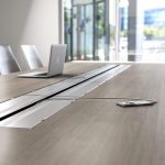 Charging a phone in a conference table with power outlets